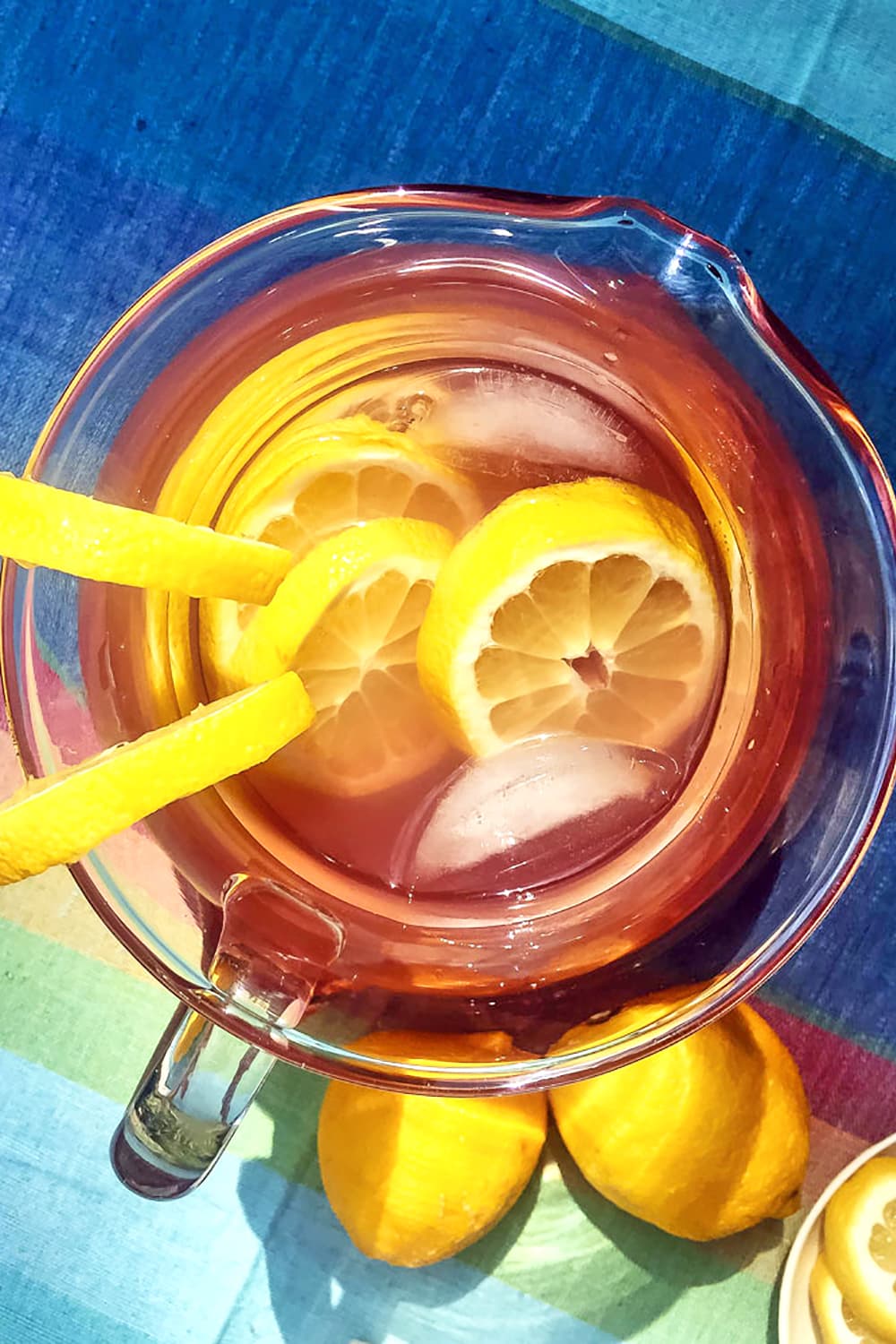 A top view of our pitcher of lavender lemonade sitting next to two lemons
