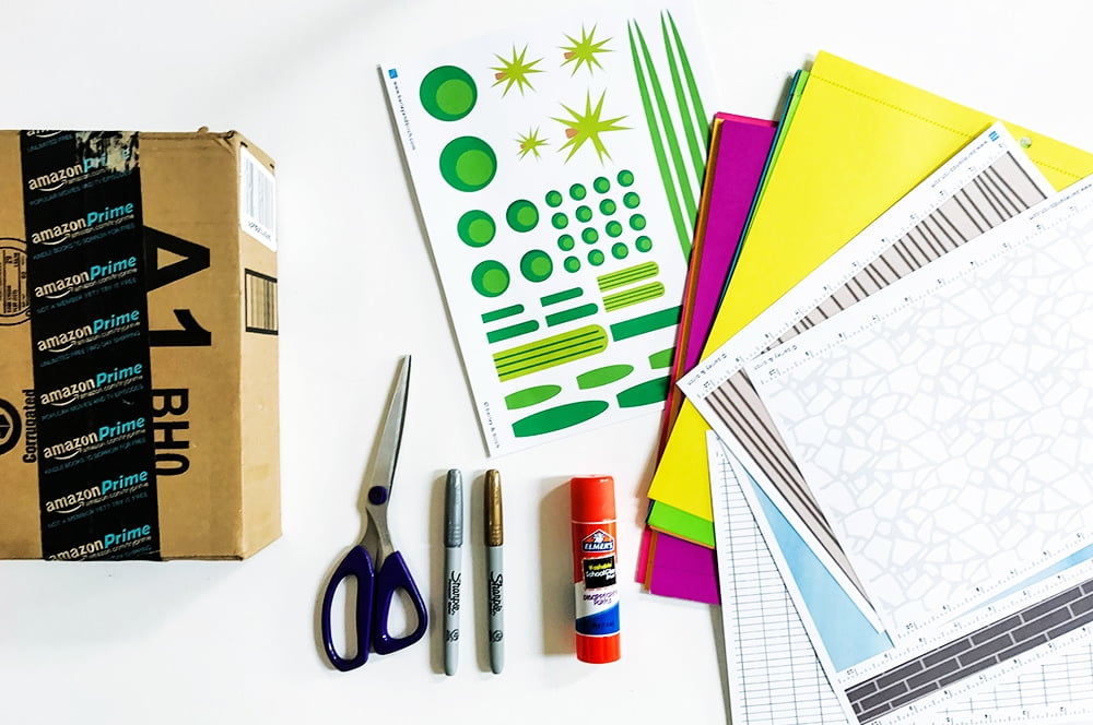 Create your own storybook mid-century modern DIY shoebox house using a cardboard box and collaging textures and simple shapes. A great rainy day activity for kids of any age!