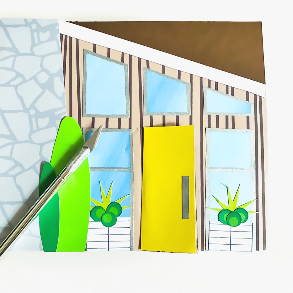 Create your own storybook mid-century modern DIY shoebox house using a cardboard box and collaging textures and simple shapes. A great rainy day activity for kids of any age!