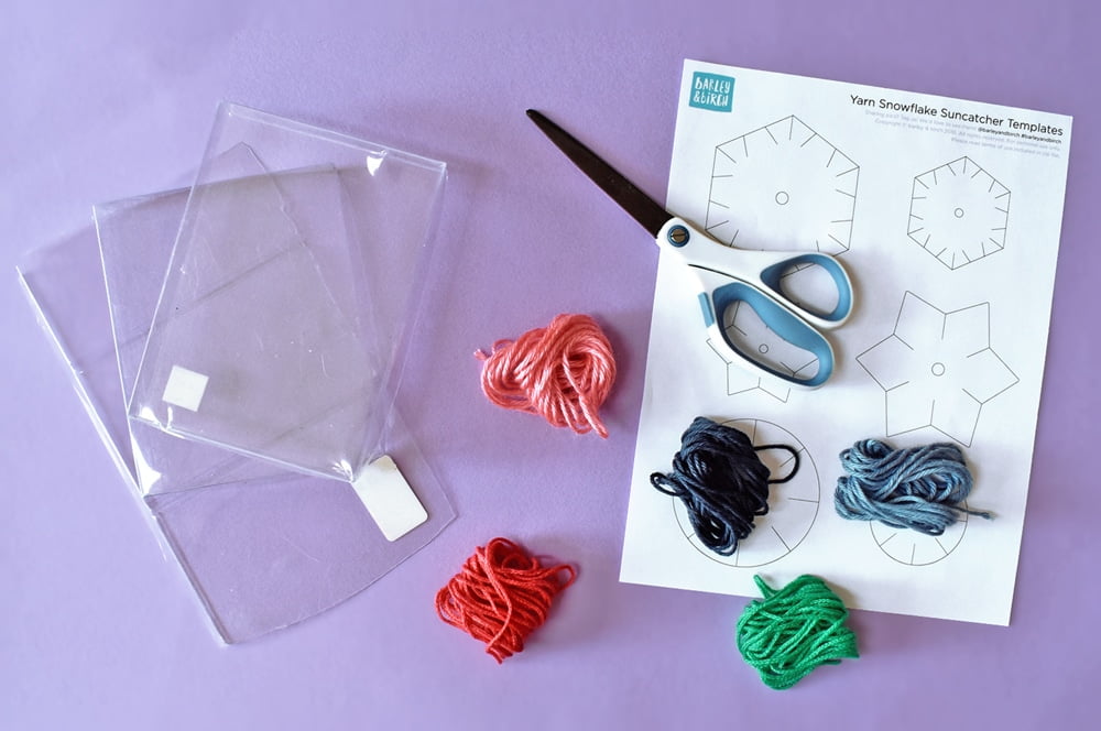 Upcycle plastic containers to make these lovely and simple yarn-wrapped snowflake ornaments!