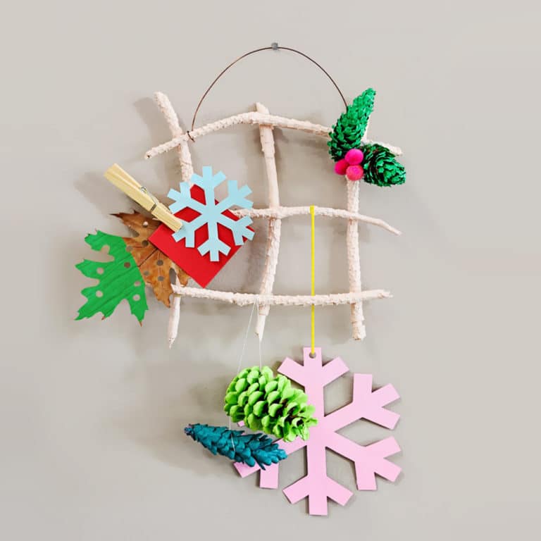 Use simple nature supplies to make your own DIY hanging holiday card holder. A festive activity for kids! | via barley & birch