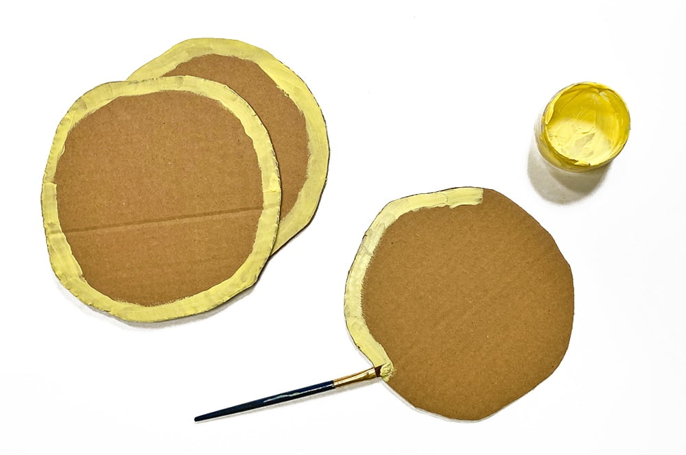 Painting the cardboard pancake circles for Paul Bunyan Play Pancakes