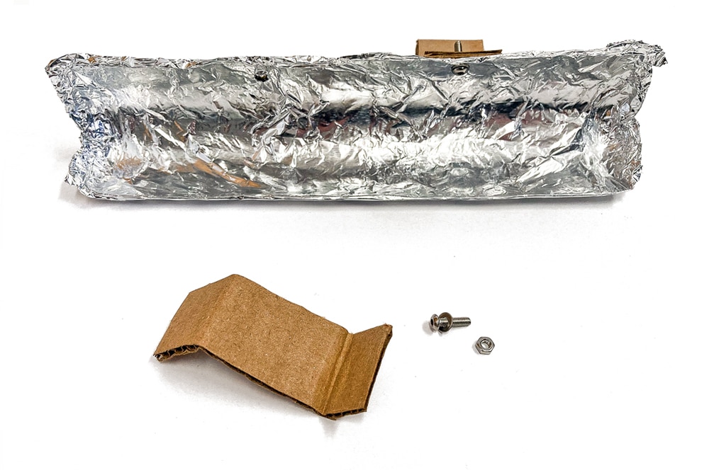 Bend small strips of cardboard to create arms that attach the shovel to the front of your snow plow. | via barley & birch