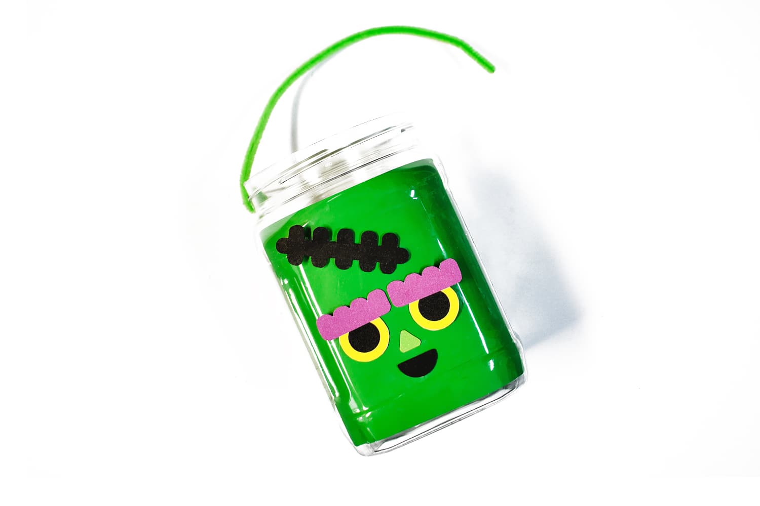 Thread a pipe cleaner or ribbon through the holes at the top of the pail and knot to create a handle.
