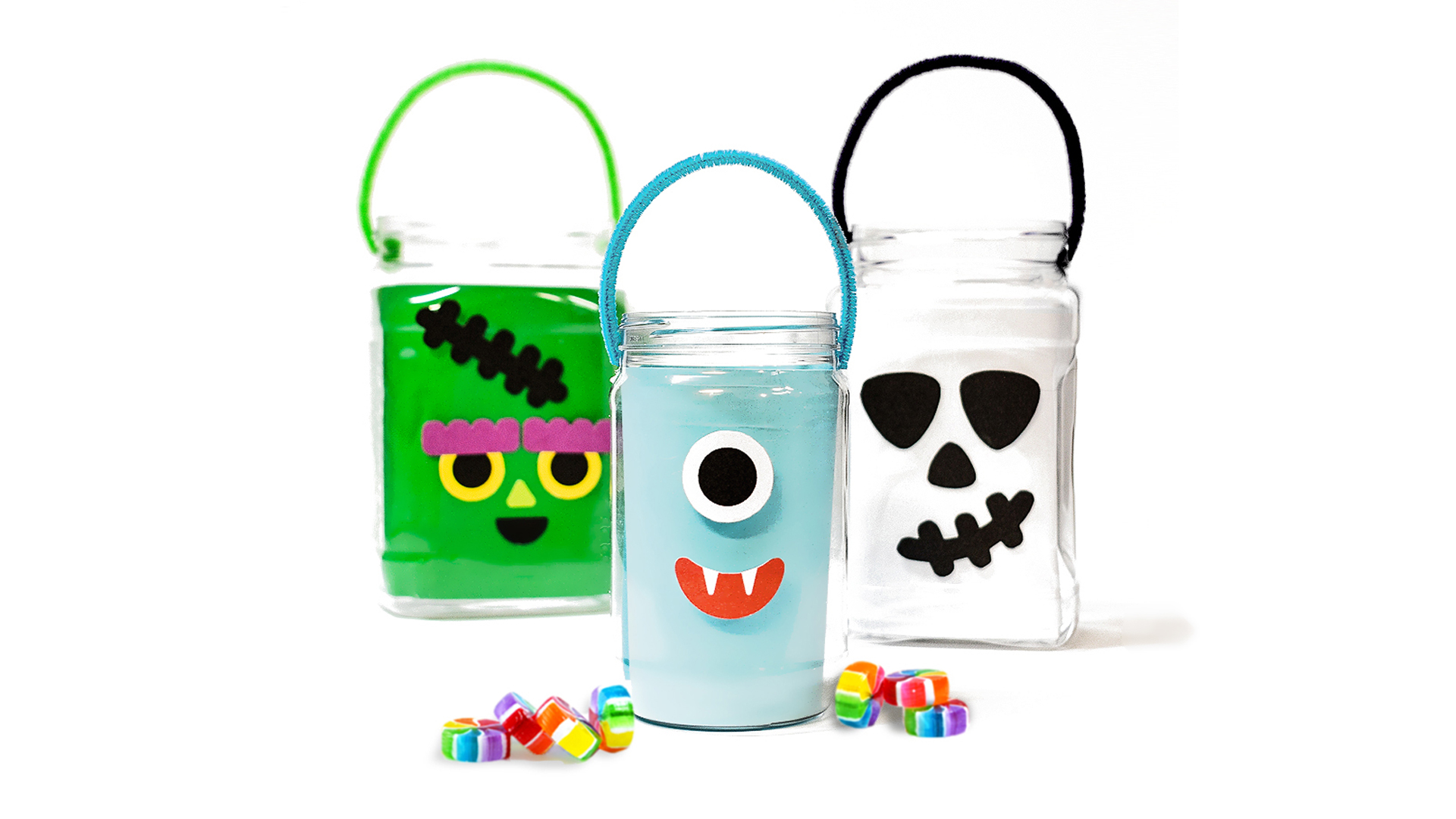 Our DIY trick-or-treat pails sitting in front of a white background with candy.
