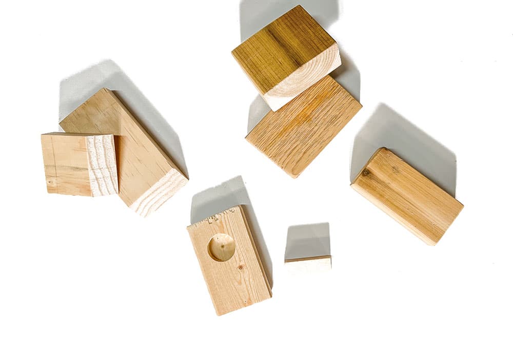 Pieces of scrap wood stacked on a white background