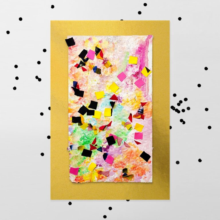 One of our confetti art projects sitting on a white background covered with confetti