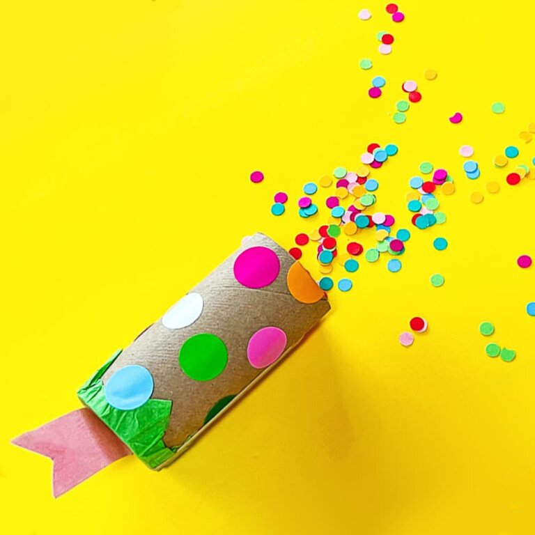 Our recycled confetti popper sitting on a yellow background sprinkled with confetti