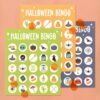 Our Halloween bingo cards sitting on a light orange background
