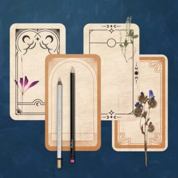 diy-tarot-card-set-art-prompt-for-kids Four of our DIY tarot cards sitting on a dark blue painted background with dried foliage and pencils